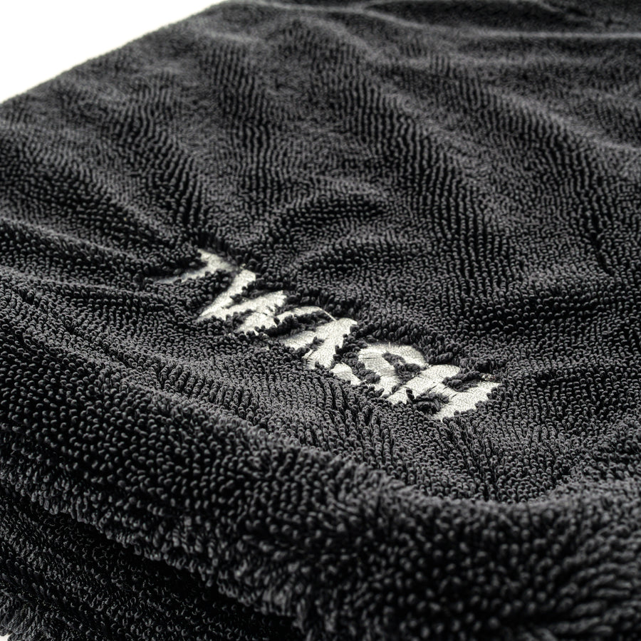 Close-up of the 7WASH logo on the drying towel