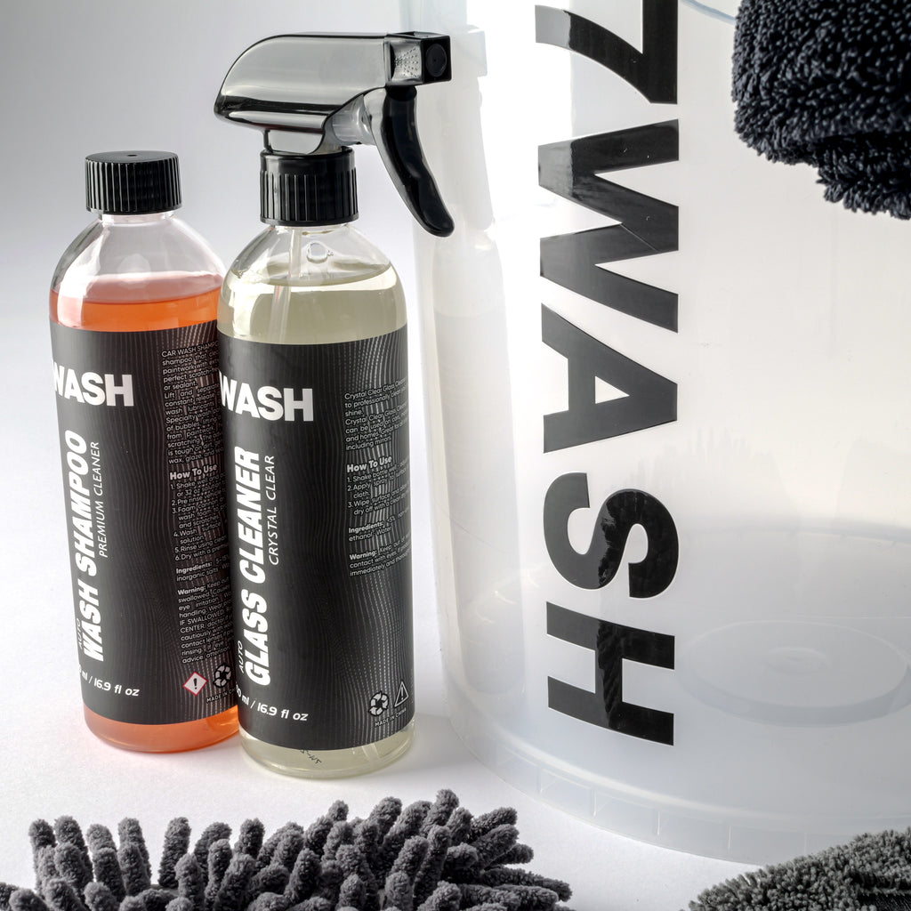 7WASH Basic Wash car care kit in a transparent 19L bucket including car shampoo, glass cleaner, microfiber wash mitt, plus a drying and buffing towel for paint and window cleaning.